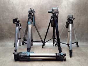 Five camera tripods with extendable legs including Optex