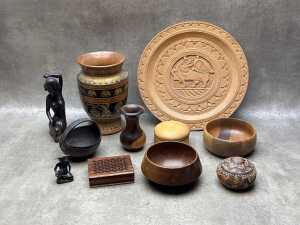 Assorted carved timber items including sculptures, turned wood vase, bowls, etc.