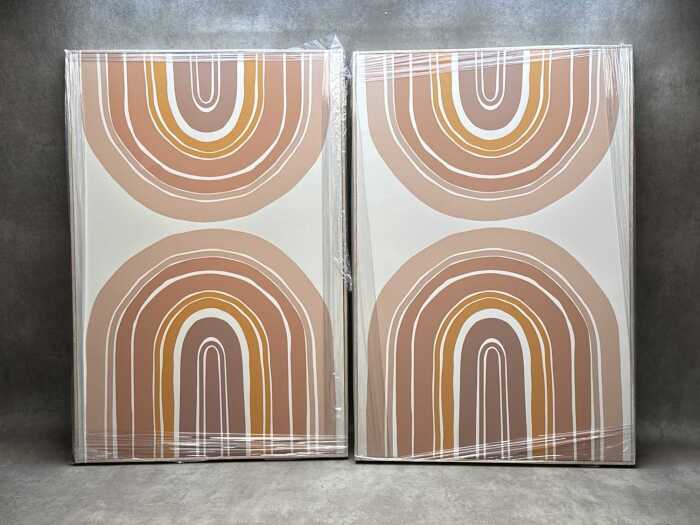 Pair of geometric prints on canvas in timber frames
