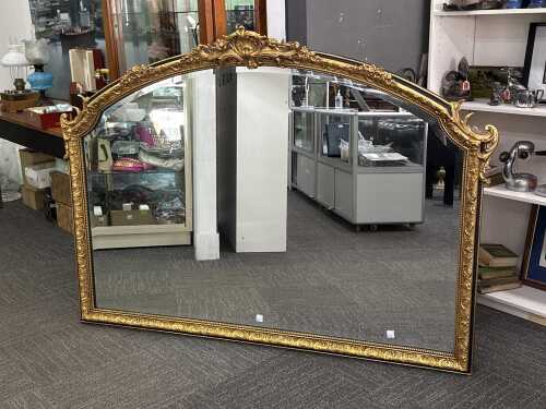 Ornate gilt framed over mantle arched wall mirror