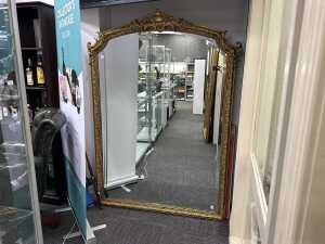 Ornate gilt framed wall mirror