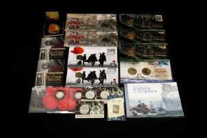 Group of Remembrance themed collectable coins and PNCs
