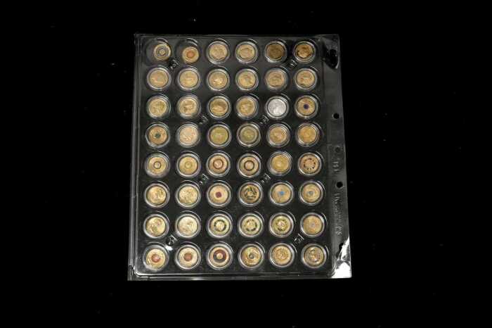 A card of 48 mostly coloured $2 coins