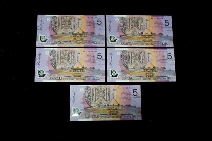 Five early polymer $5 notes