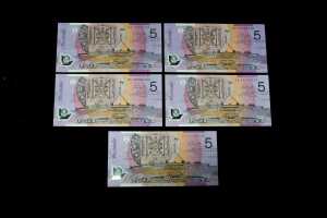 Five early polymer $5 notes