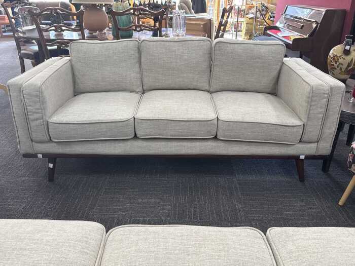 Modern three-seater upholstered sofa