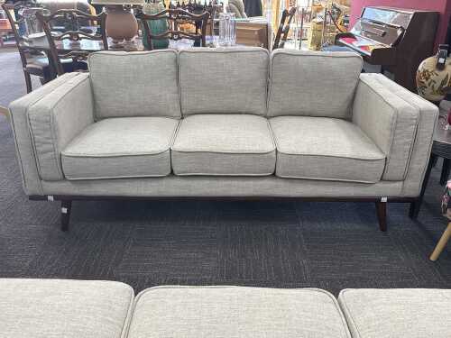 Modern three-seater upholstered sofa