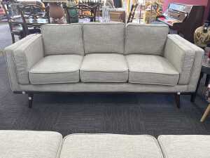 Modern three-seater upholstered sofa