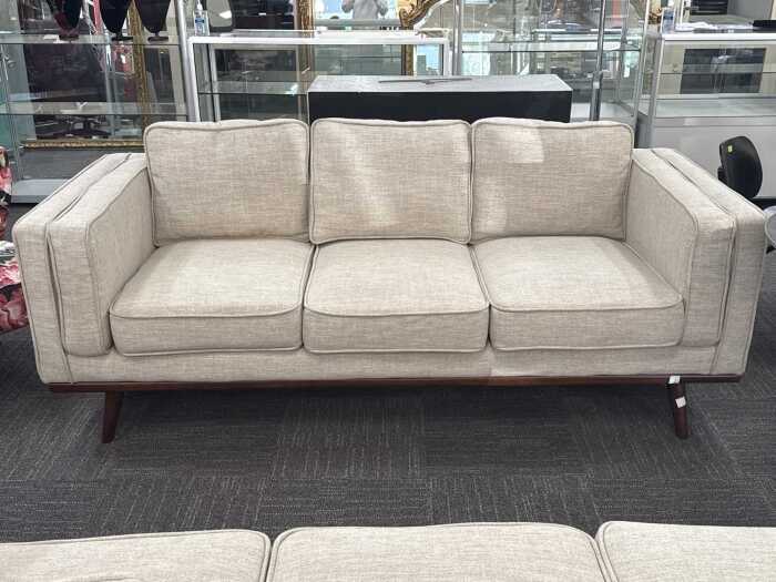Modern three-seater upholstered sofa