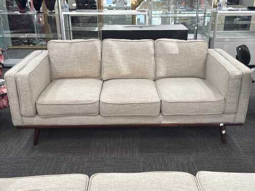 Modern three-seater upholstered sofa