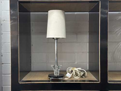 Art Deco table lamp with black and clear glass base and chrome stem.