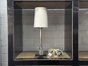 Art Deco table lamp with black and clear glass base and chrome stem.