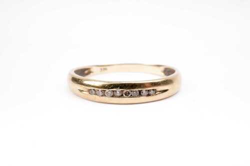 A diamond band in 9 carat yellow gold