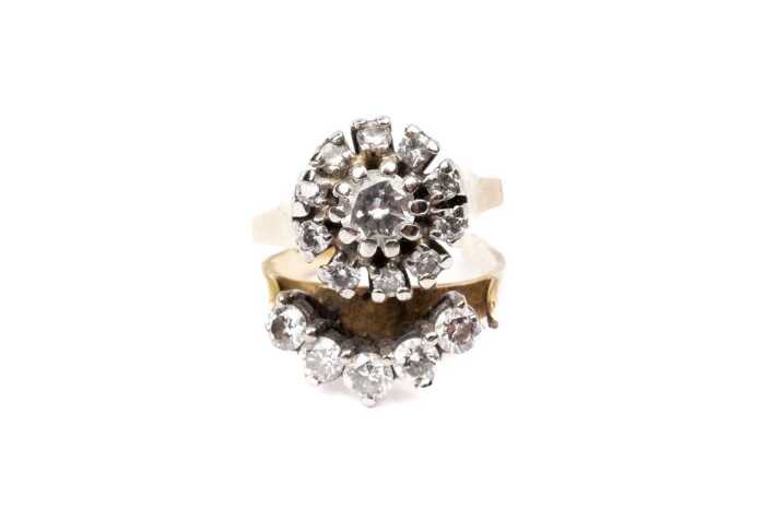 A broken soldered two diamond ring set in 18 carat and platinum