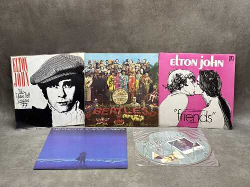 Five vinyl records, including The Beatles