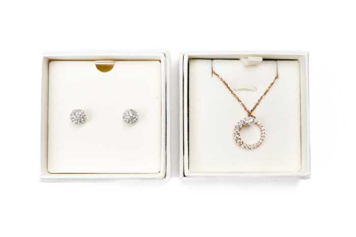 A pairs of Swarovski earrings and pendant