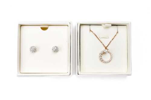A pairs of Swarovski earrings and pendant