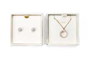 A pairs of Swarovski earrings and pendant