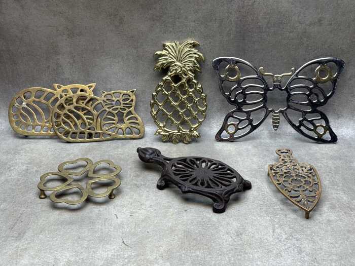 Seven metal trivets