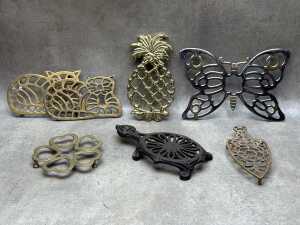 Seven metal trivets