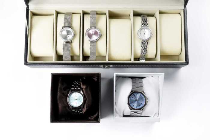 Five fashion watches and display case