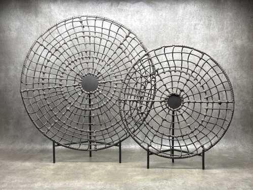 Two decorative, brown, woven sculptural pieces with stands 70cm