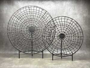 Two decorative, brown, woven sculptural pieces with stands 70cm