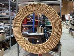 Round wall mirror in woven wicker frame