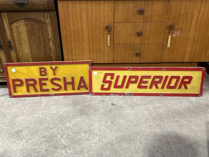 Two yellow and red painted cast metal signs