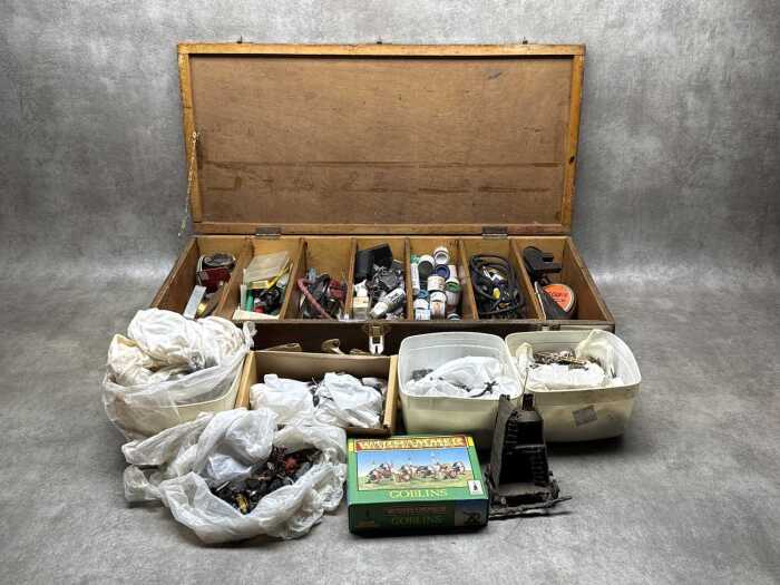 Warhammer figurines and hobbyist figure-making tools in timber box.