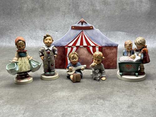 Five Goebel Hummel porcelain figures and a backdrop