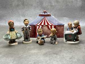 Five Goebel Hummel porcelain figures and a backdrop