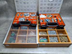 Four tool organisers filled with assorted screws, wall plugs, and bolts
