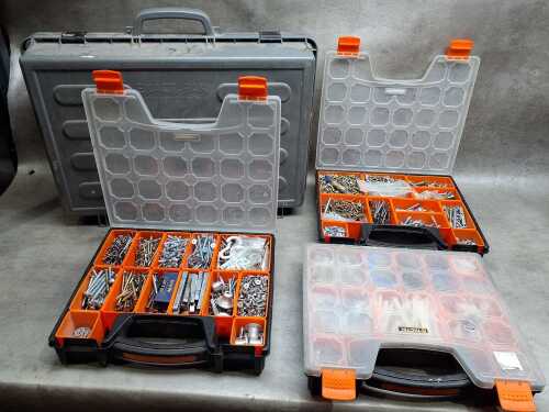 Four tool organisers filled with assorted screws, wall plugs, and bolts