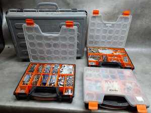 Four tool organisers filled with assorted screws, wall plugs, and bolts
