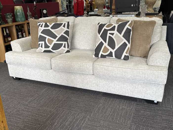 Contemporary three seat sofa in pale grey fabric