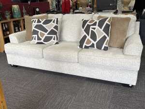 Contemporary three seat sofa in pale grey fabric