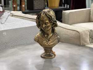 Brass-style bust of a girl wearing a bonnet