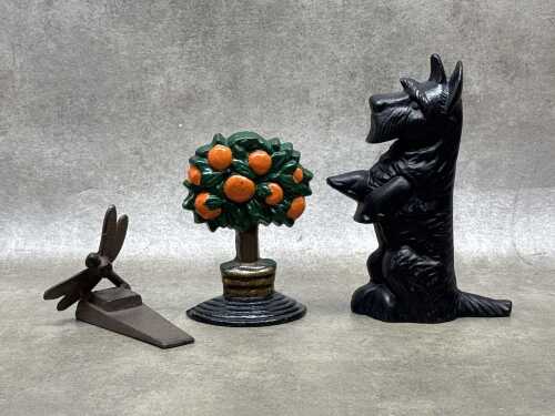 Three cast iron door stops