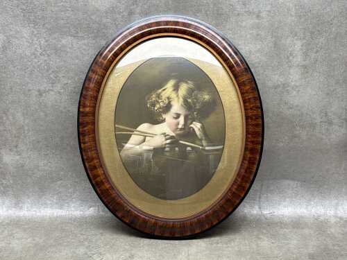 Oval frame with vintage 'Cupid Asleep' print