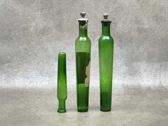 Three antique French green glass perfume bottles