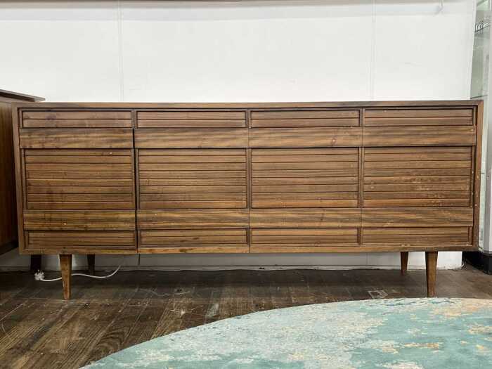 An ingenious mid-century walnut sideboard and stereo cabinet