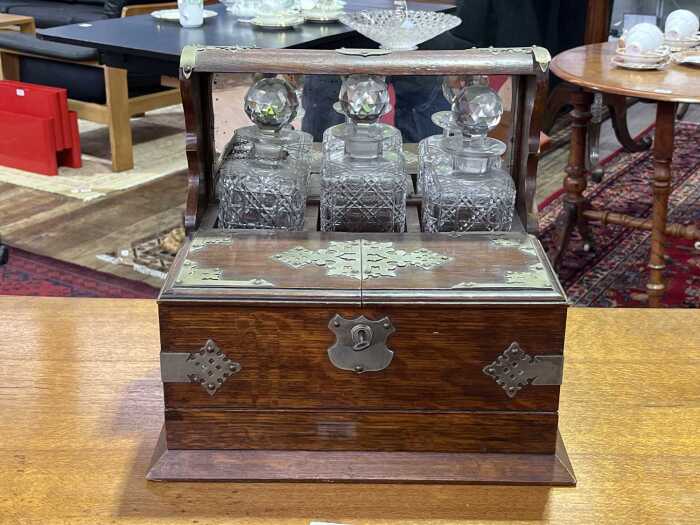 Antique oak tantalus with metal bindings and handles
