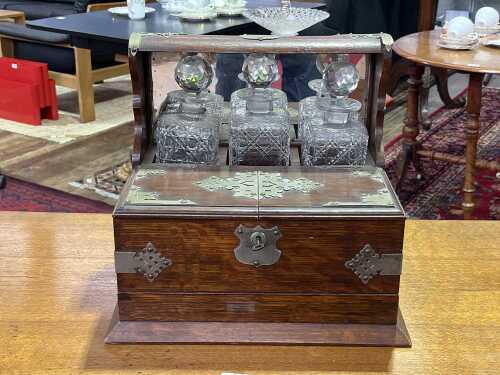 Antique oak tantalus with metal bindings and handles