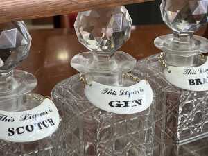Antique timber tantalus with cut crystal decanters, brass fittings and key - 2