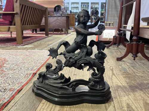 Antique cast metal figure of a twin tailed Triton or merman