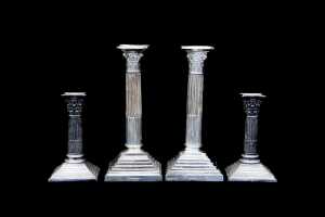 Two pairs of Neoclassical silver plated candlesticks