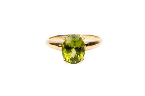 A peridot ring in 18 carat yellow gold