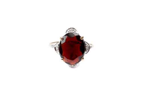 A garnet and diamond ring in 9 carat yellow gold