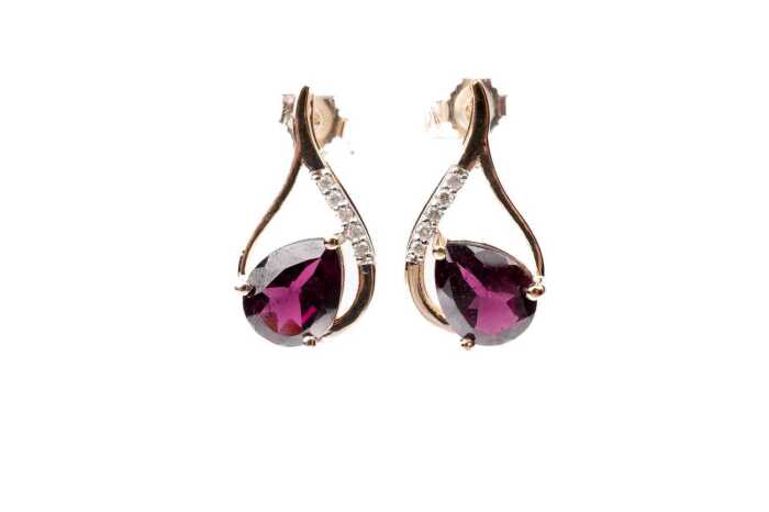 A pair of garnet and diamond earrings in 9 carat yellow gold
